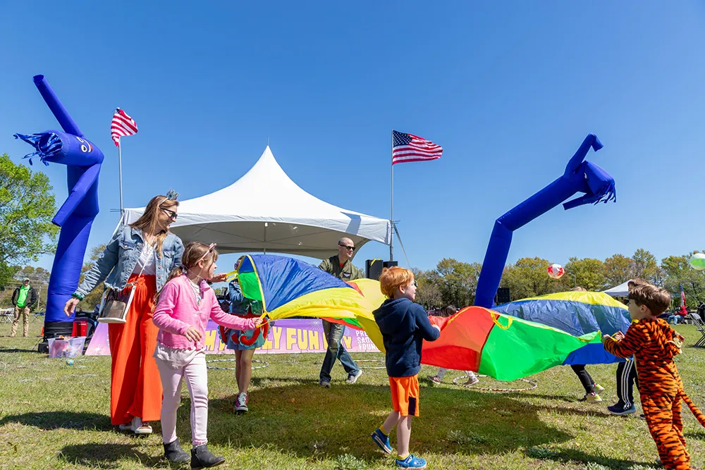 family playing with a parachute at purim festival