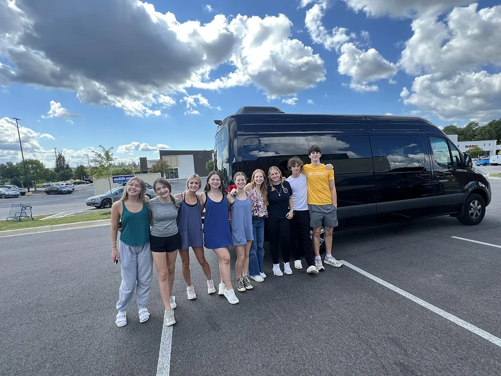 teens gathered outside a bus getting ready for a trip