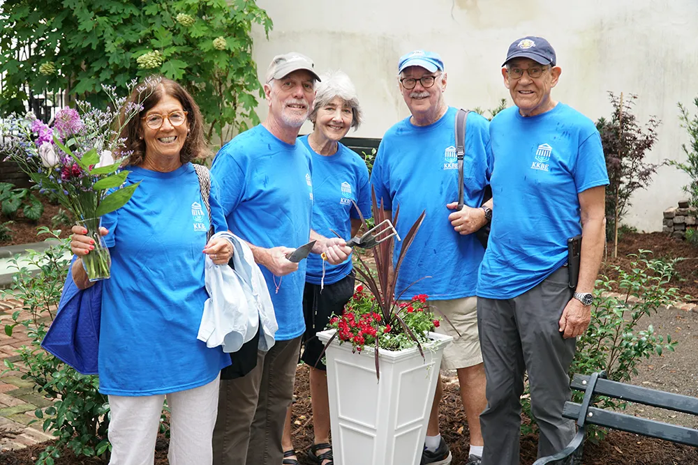 volunteers gathered with gardening tools