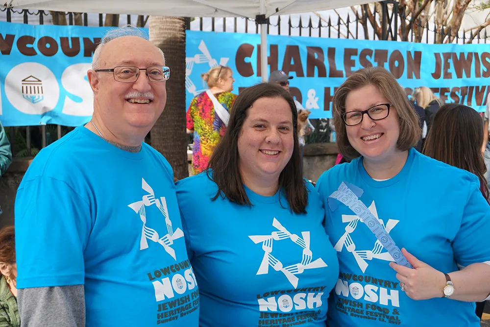 Rabbi with two volunteers are the Nosh event